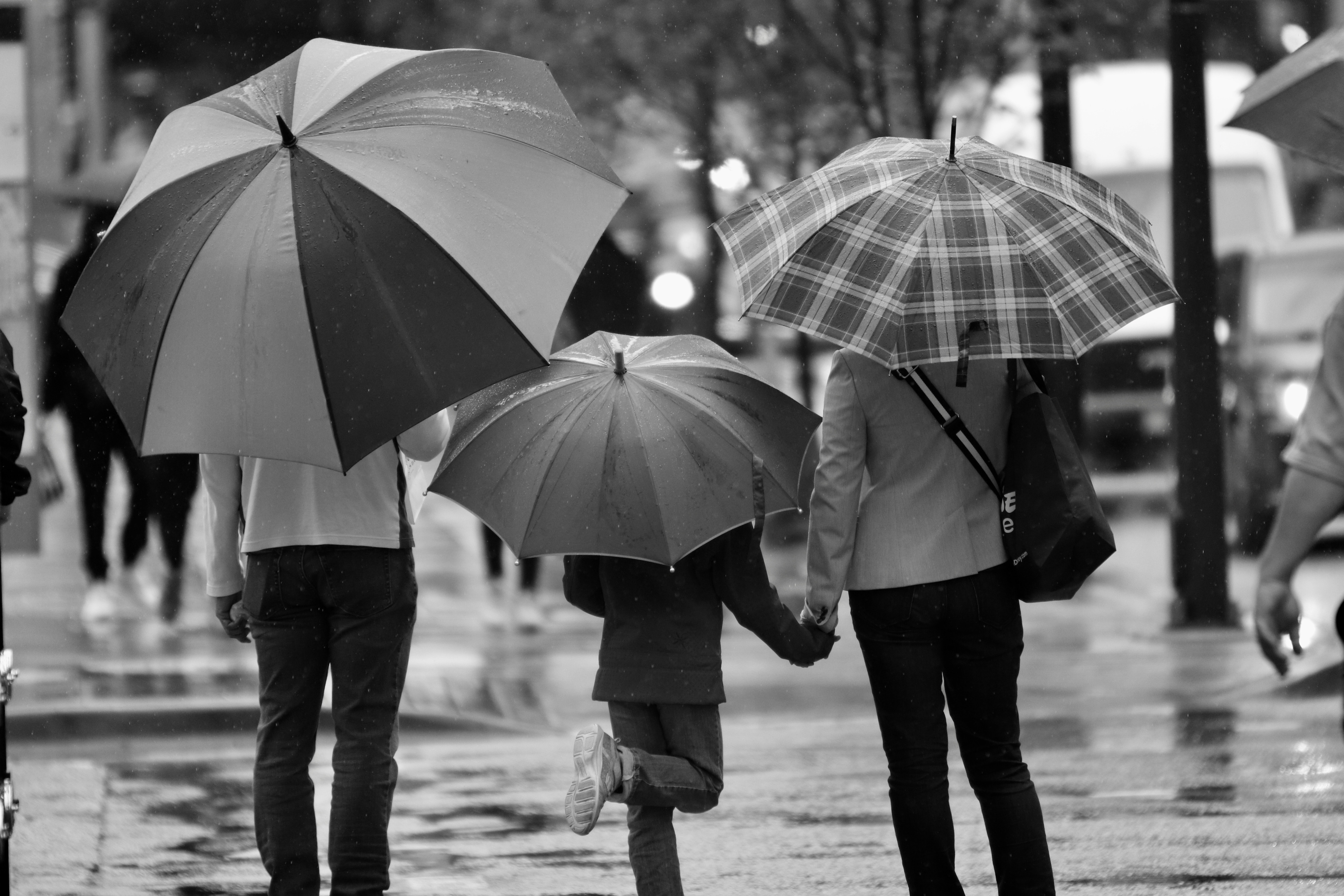 Family and their daugther, which each of them have an umbrella